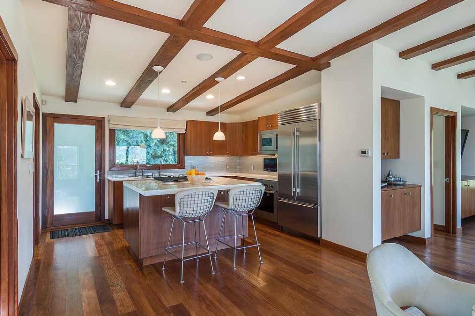 3) Exposed beams add character to the inviting kitchen.