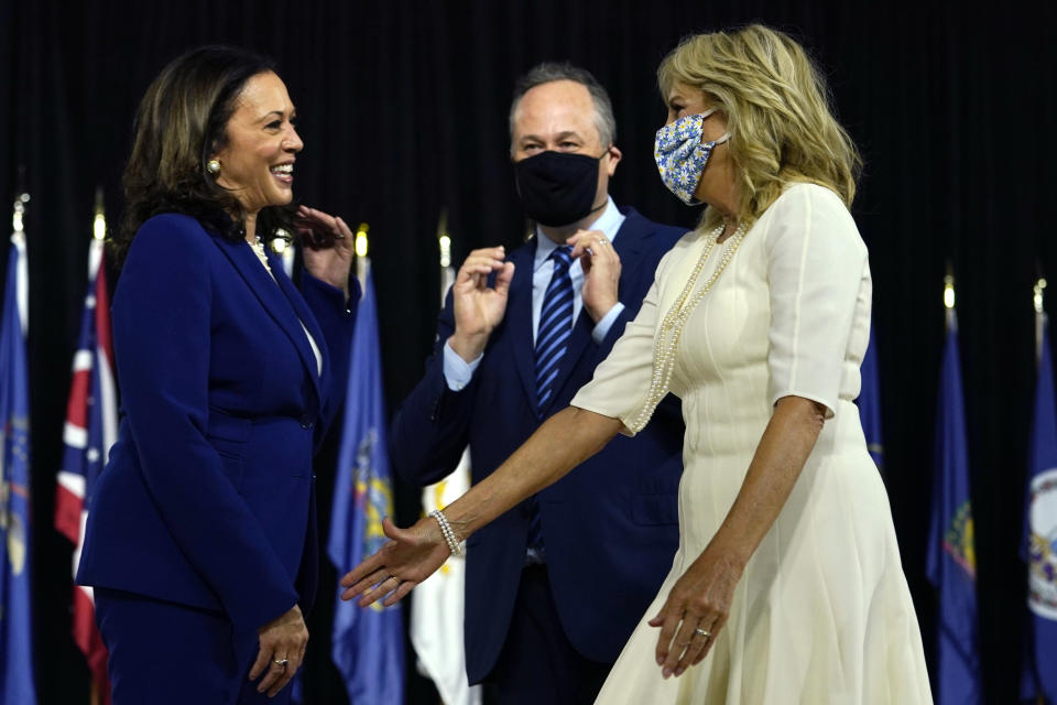 Sen. Kamala Harris, D-Calif., and her husband Douglas Emhoff greet Jill Biden, wife of Democratic presidential candidate former Vice President Joe Biden, after a campaign event at Alexis Dupont High School in Wilmington, Del., Wednesday, Aug. 12, 2020. (AP Photo/Carolyn Kaster)