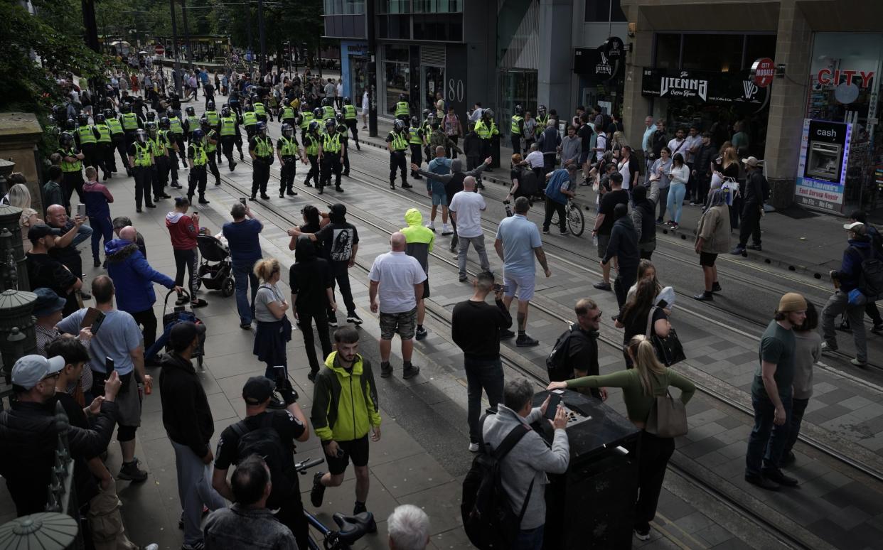 Police and rioters clash in Manchester on Aug 3