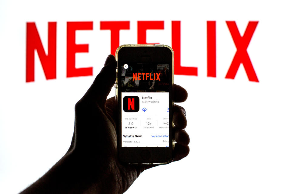 SPAIN - 2021/03/23: In this photo illustration the Netflix App seen displayed on a smartphone screen in App Store and the Netflix logo in the background. (Photo Illustration by Thiago Prudêncio/SOPA Images/LightRocket via Getty Images)