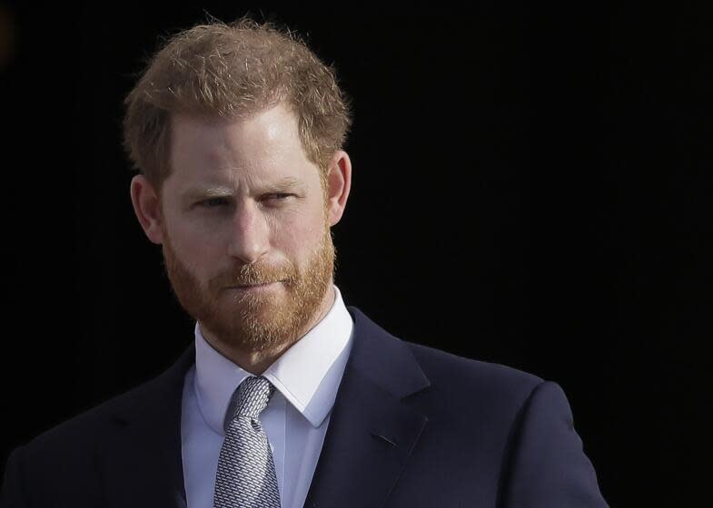 Prince Harry wearing a blue suit and gray tie