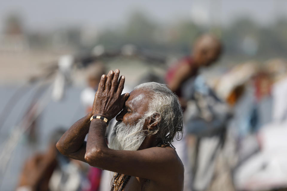 A Hindu man offers prayers at the confluence of rivers Ganges and Yamuna in Prayagraj, India, Sunday, April 25, 2021. After having largely tamed the virus last year, India is in the throes of the world’s worst coronavirus surge and many of the country’s hospitals are struggling to cope with shortages of beds, medicines and oxygen. (AP Photo/Rajesh Kumar Singh)