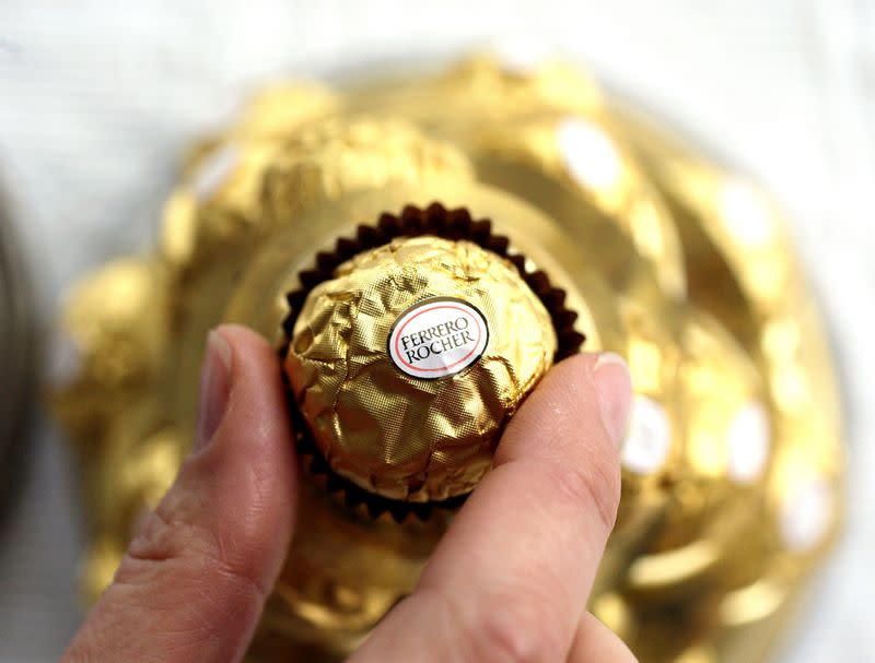 FILE PHOTO: A woman takes a Ferrero Rocher chocolate in Milan