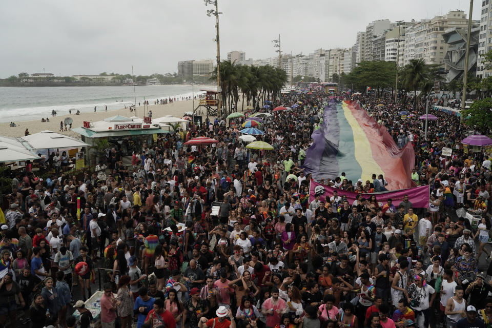 People carry a giant gay pride flag during the annual pride parade along Copacabana beach in Rio de Janeiro, Brazil, Sunday, Sept. 22, 2019. The 24th gay pride parade titled this year's parade: "For democracy, freedom and rights, yesterday, today and forever." (AP Photo/Leo Correa)
