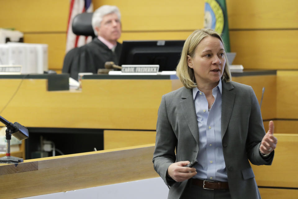 Assistant Washington state Attorney General Lori Nicolavo, right, makes her opening arguments, Tuesday, Feb. 18, 2020, in Pierce County Superior Court in Tacoma, Wash., on the first day of a civil lawsuit over the murder of Charlie and Braden Powell, who were attacked and killed by their father Josh Powell in 2012 while he was under suspicion for the disappearance of his wife, Susan Powell in Utah. The boys' grandparents allege that negligence by the Washington state Department of Social and Health Services was a contributing factor that led to the deaths of their grandsons. (AP Photo/Ted S. Warren)