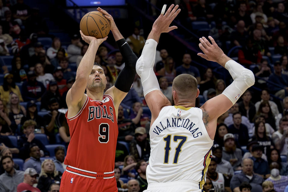 Chicago Bulls center Nikola Vucevic (9) looks to shoot over New Orleans Pelicans center Jonas Valanciunas (17) during the first half of an NBA basketball game in New Orleans, Sunday, Feb. 25, 2024. (AP Photo/Matthew Hinton)