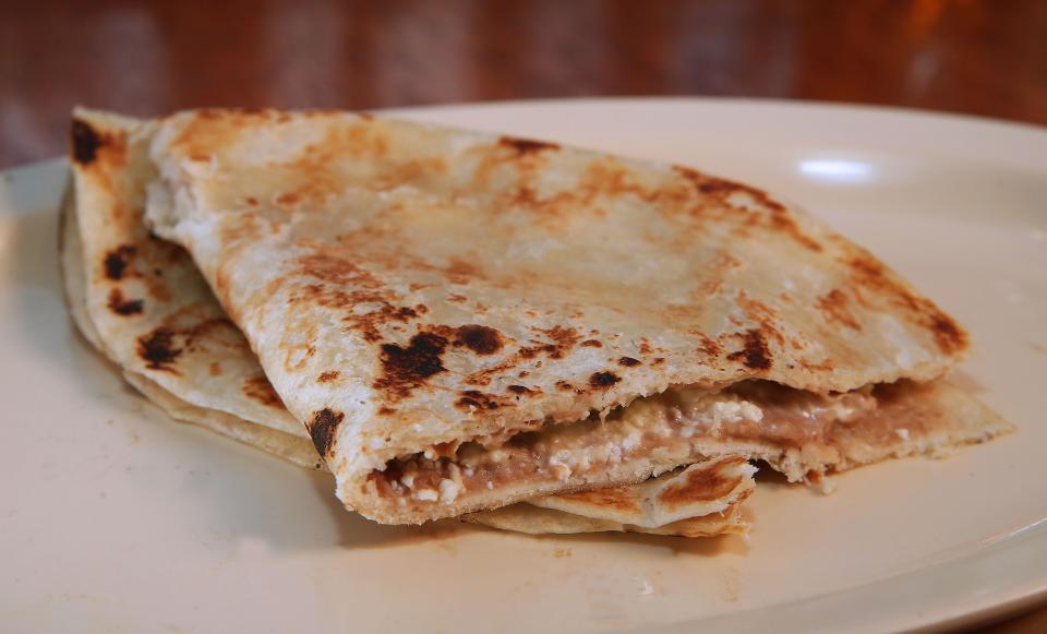 A baleada is a thick flour tortilla filled with refried beans, Honduran cream, eggs, crumbled cheese and sometimes avocado.