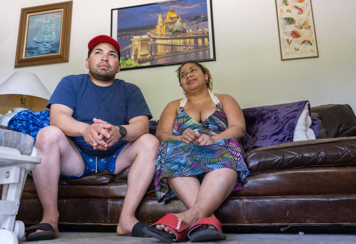 Jose Castellanos and his wife Margarita Yanez sit in the home of an acquaintance in Sacramento earlier this month.