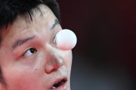 <p>China's Fan Zhendong serves to South Korea's Jang Woo-jin during their men's team semifinal table tennis match at the Tokyo Metropolitan Gymnasium during the Tokyo 2020 Olympic Games in Tokyo on August 4, 2021. (Photo by ADEK BERRY / AFP)</p> 