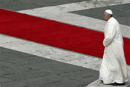 Pope Francis walks away at the end of a mass to prepare an urn containing the relics of the Apostle St. Peter for public veneration, at the Vatican November 24, 2013. REUTERS/Stefano Rellandini