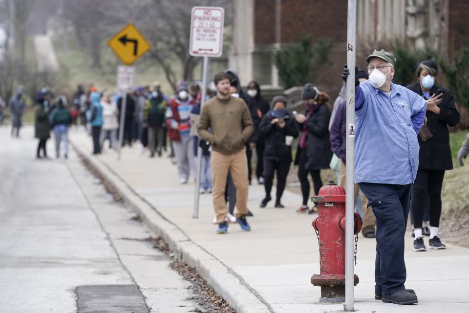 Voters masked against coronavirus line up at Riverside High School for Wisconsin's primary election, April 7 in Milwaukee. (Photo: ASSOCIATED PRESS)