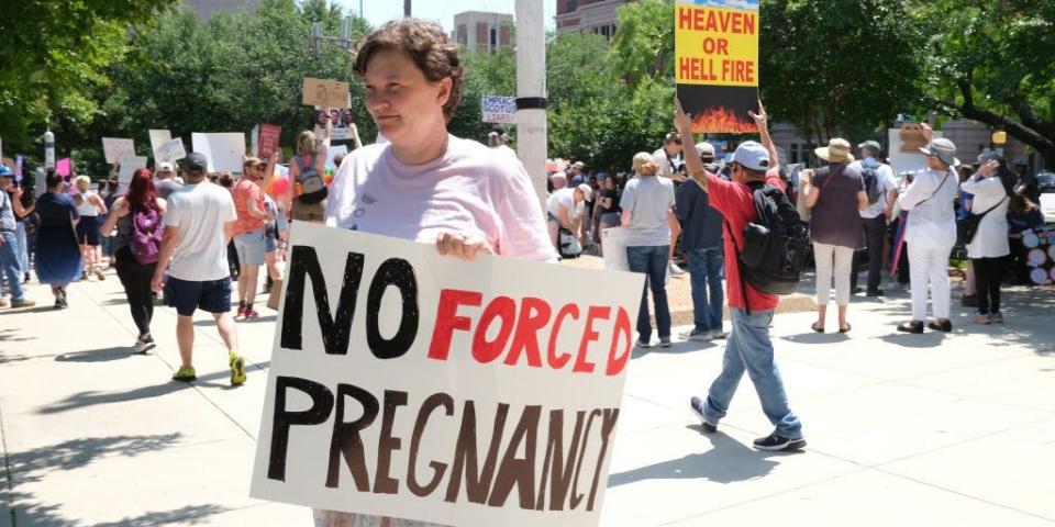 A protestor holds a sign reading "no forced pregnancy" in Texas