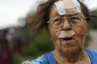 Valentyna Kondratieva, 75, stands outside her damaged home Saturday, Aug. 13, 2022, where she sustained injuries in a Russian rocket attack last night in Kramatorsk, Donetsk region, eastern Ukraine. The strike killed three people and wounded 13 others, according to the mayor. The attack came less than a day after 11 other rockets were fired at the city. (AP Photo/David Goldman)