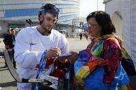 Canada's ice hockey player Patrice Bergeron signs an autograph following a men's team practice at the 2014 Sochi Winter Olympics February 20, 2014. REUTERS/Brian Snyder