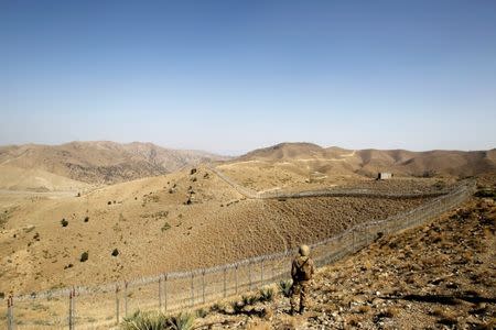 A soldier stands guard along the border fence outside the Kitton outpost on the border with Afghanistan in North Waziristan, Pakistan October 18, 2017. REUTERS/Caren Firouz