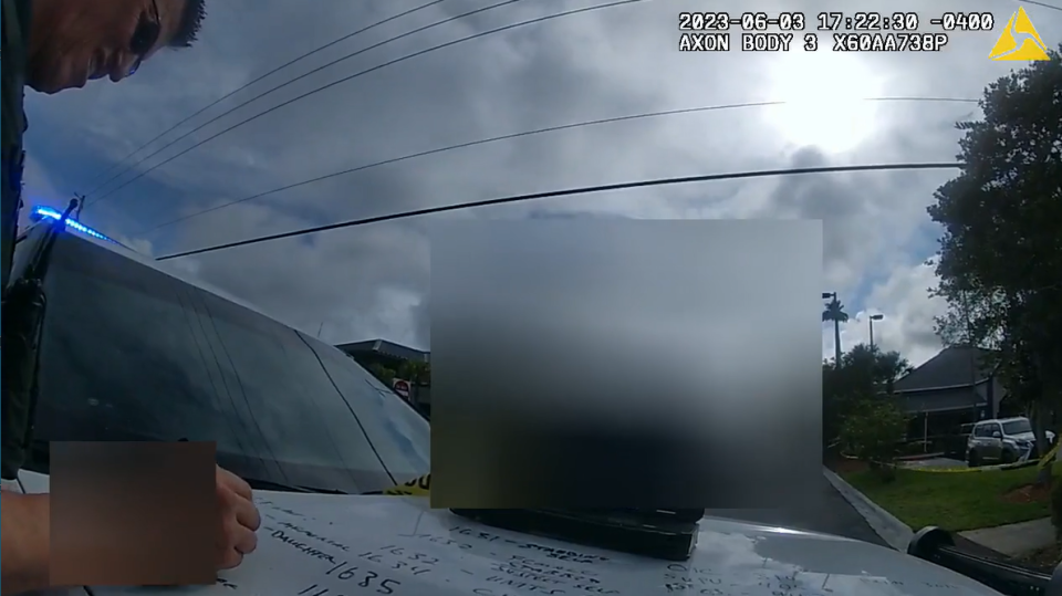 St. Johns County sheriff's officers jot out the timeline on the hood of a patrol vehicle following the June 3 stabbing at Mr. Chubby's Wings in Ponte Vedra Beach.