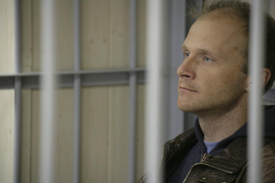 Photographer Denis Sinyakov looks out from a defendants' box at the Leninsky District Court Of Murmansk