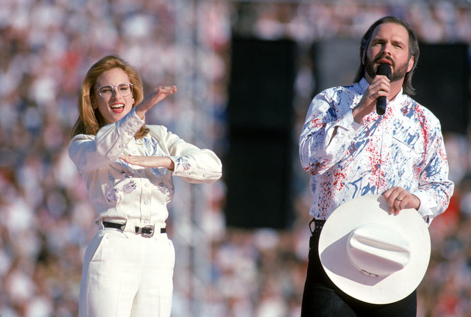 Country music star Garth Brooks sings the National Anthem with American sigh language translation preformed by actress Marlee Matlin prior to Super Bowl XXVII between the Dallas Cowboys and the Buffalo Bills at the Rose Bowl on January 31, 1993 in Pasadena, California. The Cowboys defeated the Bills 52-17.