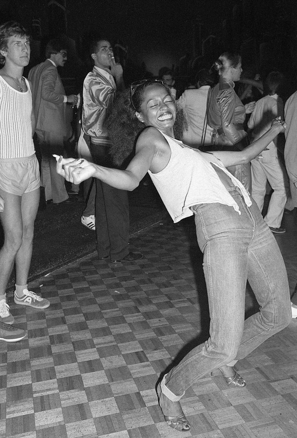<p>Diana Ross lets loose on the dance floor in 1979. The Queen of Motown kept things simple in a pair of dark wash jeans and a loose tank top. </p>