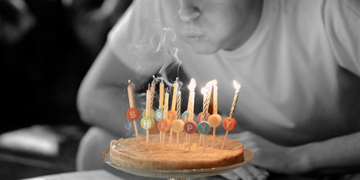 boy blowing out birthday candles on cake