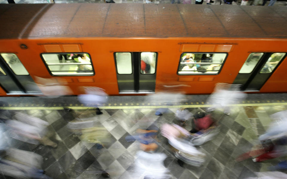 Commuters come and go inside Chapultepec subway station 13 October, 2007 in Mexico City. Mexico City's subway system has 175 stations along 202 kilometers of tracks and counts with 1599 train operators -378 women and 1221 men. The subway service of the overpopulated Mexican capital presently transports 4,3 million commuters a day, one million less than 15 years ago, PRI's local deputy Fernando Espino said to AFP. AFP PHOTO/Ronaldo SCHEMIDT (Photo credit should read Ronaldo Schemidt/AFP/Getty Images)