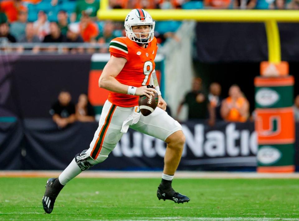 Miami Hurricanes quarterback Tyler Van Dyke (9) scrambles in the second half against the Virginia Cavaliers at Hard Rock Stadium in Miami Gardens on Saturday, October 28, 2023.