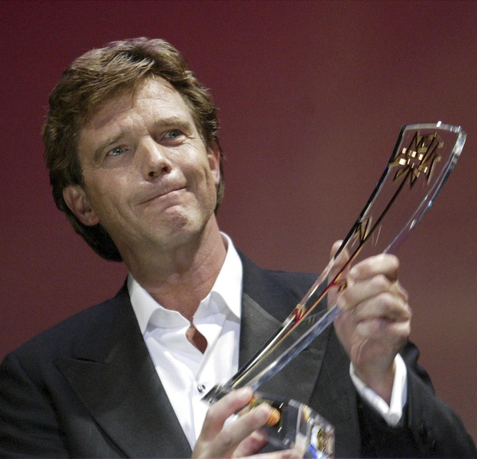 FILE- John de Mol from the Netherlands receives the Golden Rose Award 2004 in the category Honorary Golden Rose 2004 during the official award ceremony ot the 44th Rose d'Or festival at the Culture and Congress Center (KKL) in Lucerne, Switzerland, Saturday, April 17, 2004. De Mol, the former producer of Dutch talent show "The Voice of Holland" apologized Thursday Jan. 20, 2022, after allegations of sexually inappropriate conduct linked to the ratings blockbuster were aired. Police and prosecutors called reports of the alleged abuse "disturbing" and urged victims to come forward with their experiences. (AP Photo/Keystone, Urs Flueeler)