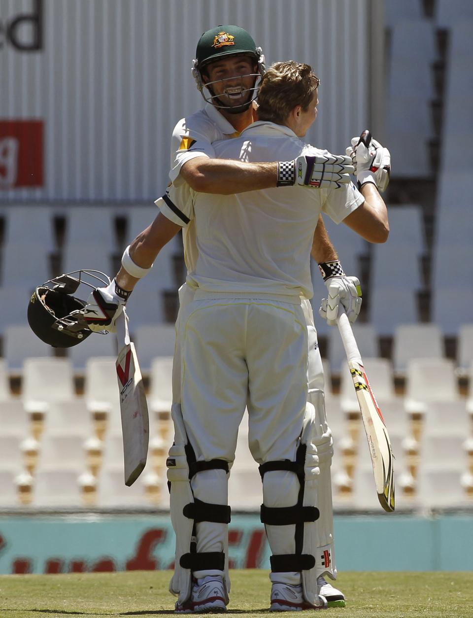 Australia's Steve Smith (front) is congratulated by teammate Shaun Marsh after he completed his century during the second day of their cricket test match against South Africa in Centurion February 13, 2014. REUTERS/Siphiwe Sibeko (SOUTH AFRICA - Tags: SPORT CRICKET)