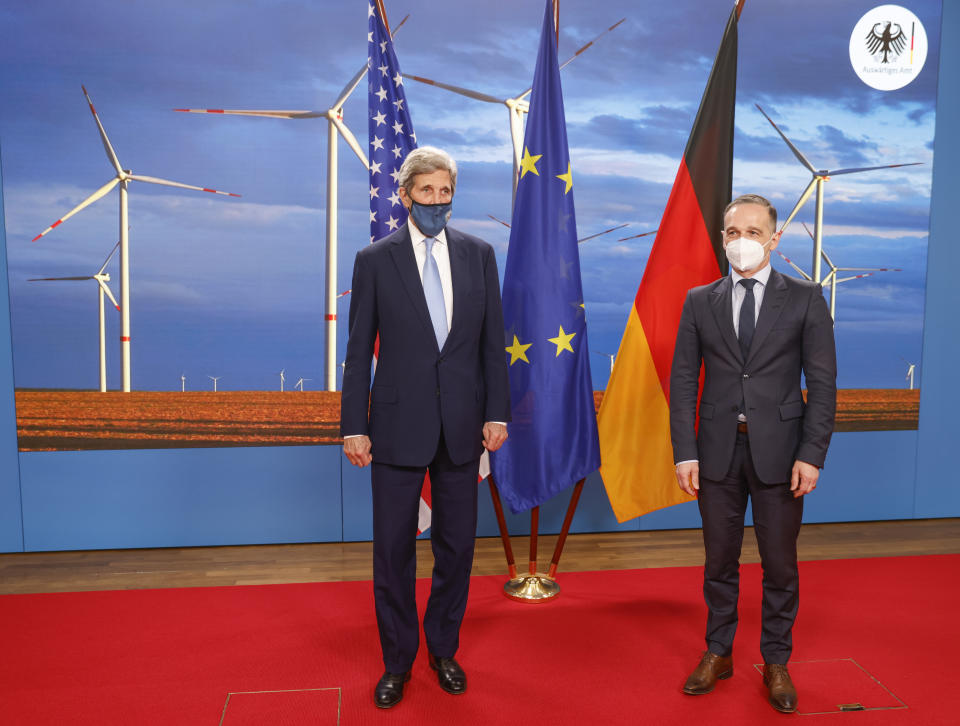 German Foreign Minister Heiko Maas, right, and the US' Special Presidential Envoy for Climate John Kerry, left, pose prior to a meeting at the Foreign Office in Berlin on Tuesday, May 18, 2021. (Odd Andersen/Pool Photo via AP)