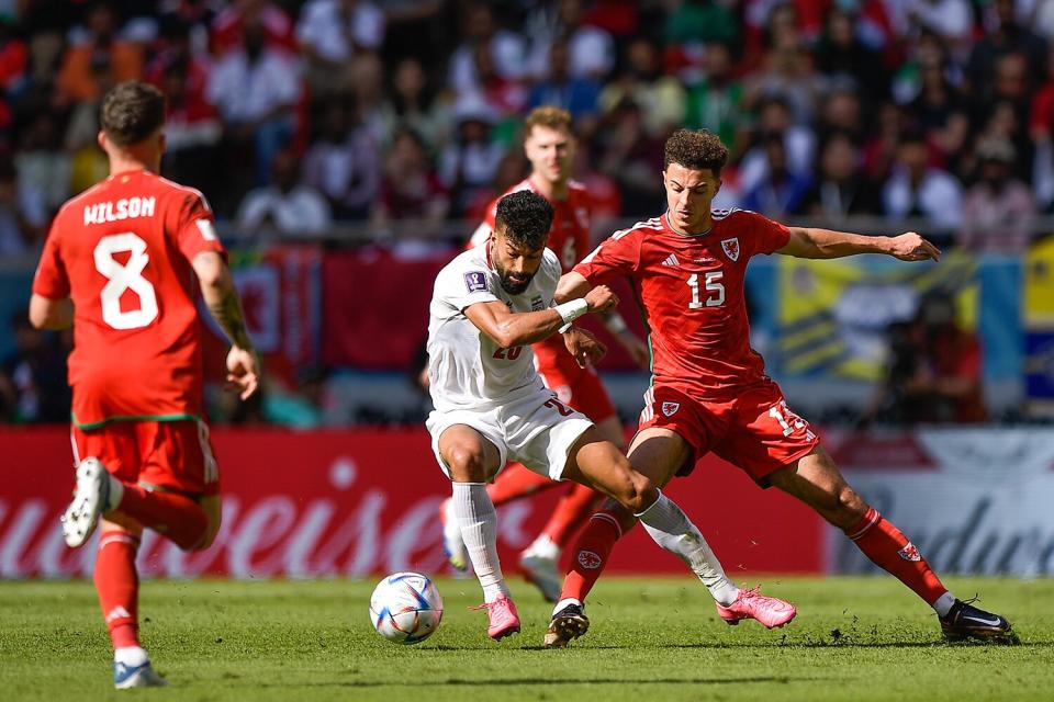 Ramin Rezaeian of IR Iran battles for the ball with Ethan Ampadu of Wales during the Group B - FIFA World Cup Qatar 2022 match between Wales and IR Iran at the Ahmad Bin Ali Stadium on November 25, 2022 in Doha, Qatar