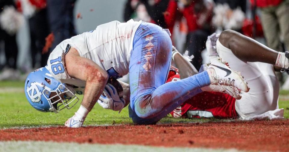 North Carolina’s John Copenhaver (81) scores on a 15-yard pass reception from quarterback Drake Maye in the second quarter against N.C. State on Saturday, November 25, 2023 at Carter-Finley Stadium in Raleigh, N.C.