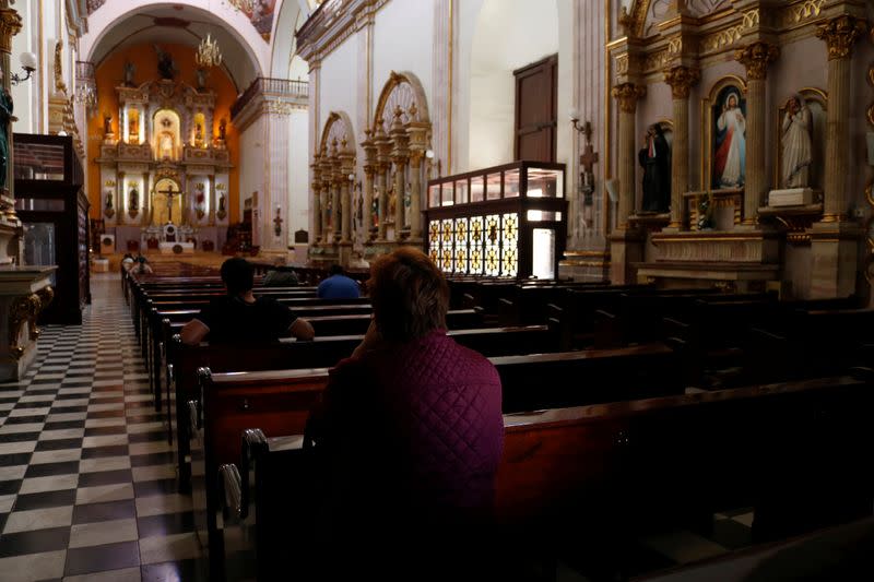 People sit in pews in the Cathedral of Our Lady of the Rosario, where the daughter of Mexican drug lord Joaquin "El Chapo" Guzman got married recently according to local media, in Culiacan