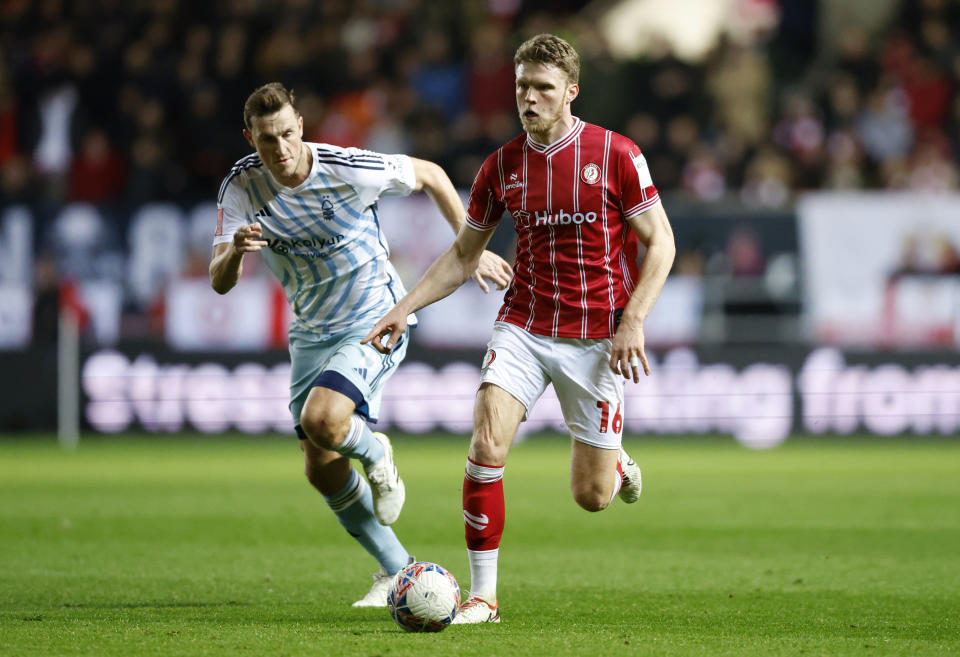 Nottingham Forest's Chris Wood, left, and Bristol City's Rob Dickie battle for the ball during their English FA Cup fourth round soccer match at Ashton Gate, Bristol, England, Friday, Jan. 26, 2024. (Nigel French/PA via AP)