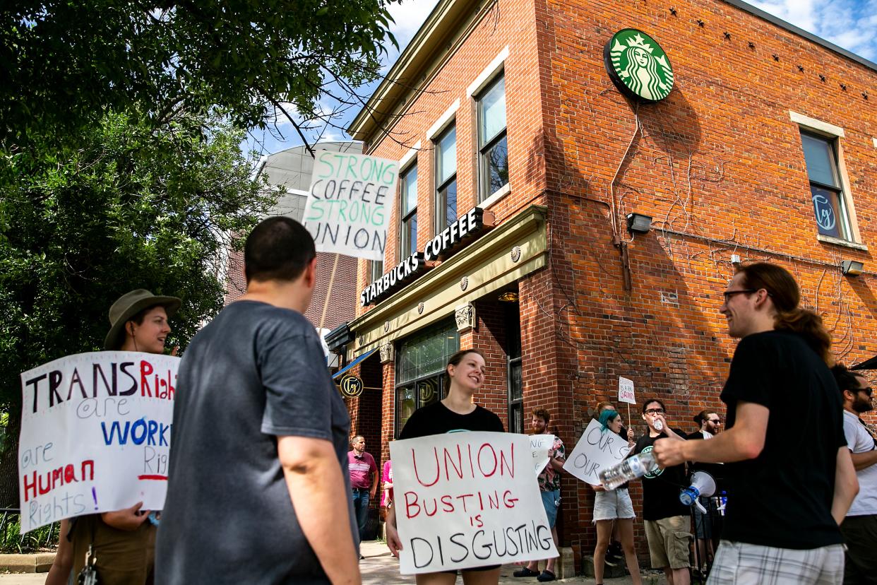 Starbucks employees hold signs as they strike, Friday, June 30, 2023, outside the 228 S Clinton St. location in Iowa City, Iowa. The employees voted 25-0 in favor of unionizing out of 30 people eligible in the election on May 11. 