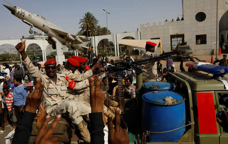 Sudanese soldiers are seen on their vehicles as they move with a military convoy outside the defense ministry compound in Khartoum, Sudan, April 25, 2019. REUTERS/Umit Bektas