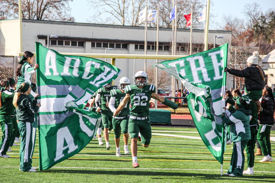 Archmere's Cole Fenice leads the team on to the field in Archmere 56-28 win over Woodbridge, Saturday, Novermber 25, 2023 in a Class 2A DIAA football semifinals in Claymont, DE.