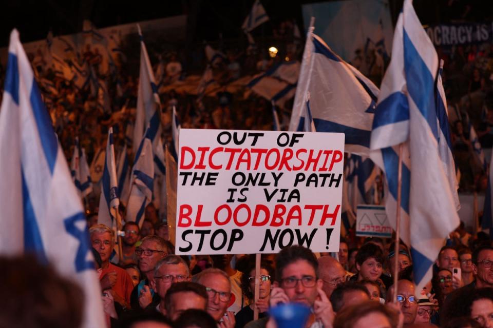 Demonstrators raise placards as they march in Jerusalem on July 22, 2023, during a multi-day march that started in Tel Aviv to protest the government’s judicial overhaul bill ahead of a vote in the parliament (AFP via Getty Images)