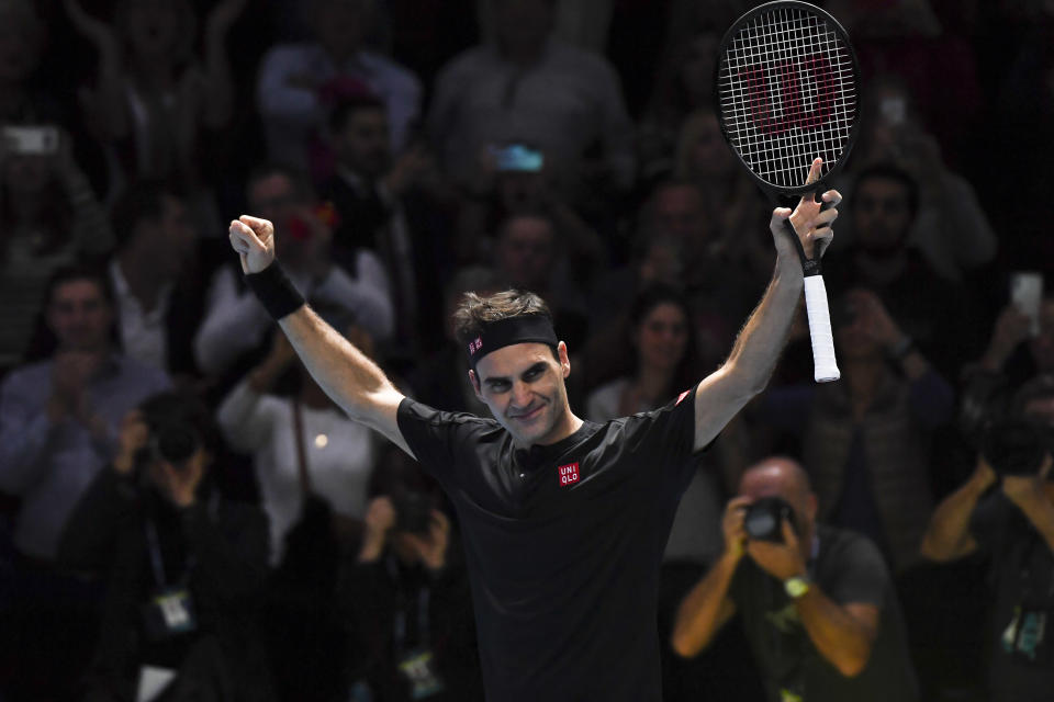 Roger Federer of Switzerland celebrates the winning match point against Novak Djokovic of Serbia during their ATP World Tour Finals singles tennis match at the O2 Arena in London, Thursday, Nov. 14, 2019. (AP Photo/Alberto Pezzali)