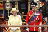 FILE - In this file photo dated Saturday, June 16, 2012, Britain's Queen Elizabeth II, and Prince Philip take a salute as the Guards march past outside Buckingham Palace after the Trooping The Color parade at Horse Guards Parade in London. Trooping the Colour is an annual ceremony marking the queen's official birthday, which takes place in June. The monarch's actual birthday was on 21 April, when she turned 86. Prince Philip who died Friday April 9, 2021, aged 99, lived through a tumultuous century of war and upheavals, but he helped forge a period of stability for the British monarchy under his wife, Queen Elizabeth II. (AP Photo/Sang Tan, FILE)