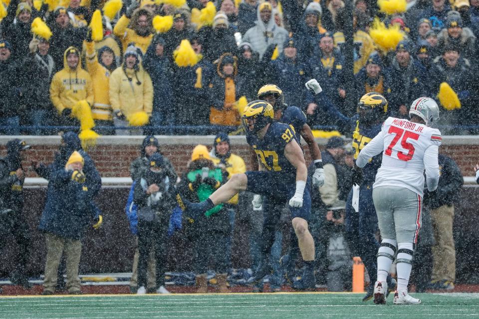 Michigan defensive end Aidan Hutchinson (97) celebrate a sack against Ohio State during the first half at Michigan Stadium in Ann Arbor on Saturday, Nov. 27, 2021.