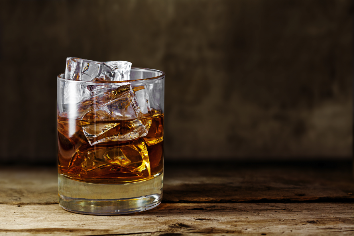 glass of whiskey with large ice cubes