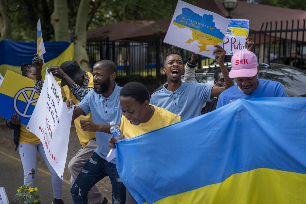 South African nationals join Ukrainians as they demonstrate outside the Russian Embassy in Pretoria, South Africa, Wednesday, Feb. 22, 2023. A group of around 40 gathered to protest against the Russian invasion of Ukraine and the joint military naval exercises being held by the South Africa Defence Force and their Russian and Chinese counterparts. (AP Photo/Jerome Delay)