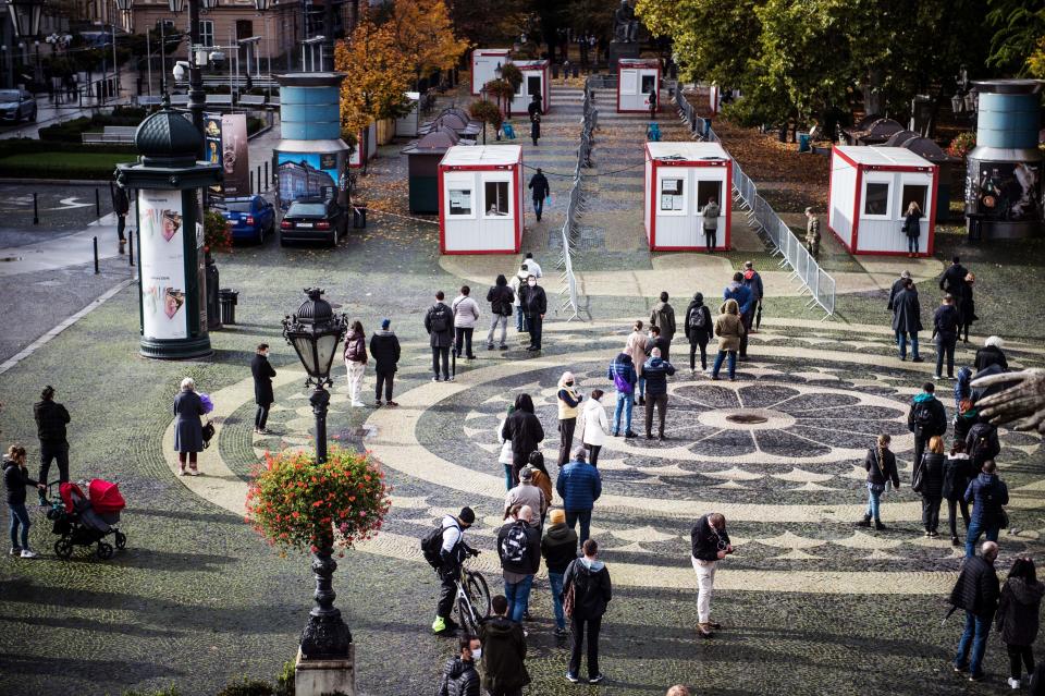 People queue for test for the novel coronavirus COVID-19 during nationwide testing in Bratislava, Slovakia on October 31, 2020. - Slovakia on october 31, 2020 began a programme to screen its entire population for coronavirus but medical professionals have warned it could lead to an increase in cases. Some 45,000 medical workers, army and police are being deployed to carry out the tests in the EU member state of 5.4 million people, collecting swabs at around 5,000 testing points. (Photo by VLADIMIR SIMICEK / AFP) (Photo by VLADIMIR SIMICEK/AFP via Getty Images)