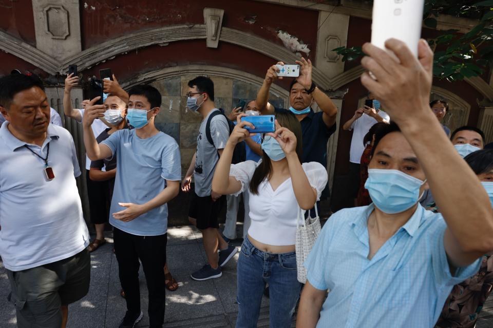 People take photos outside the United States Consulate in Chengdu in southwest China's Sichuan province on Sunday, July 26, 2020. China ordered the United States on Friday to close its consulate in the western city of Chengdu, ratcheting up a diplomatic conflict at a time when relations have sunk to their lowest level in decades. (AP Photo/Ng Han Guan)