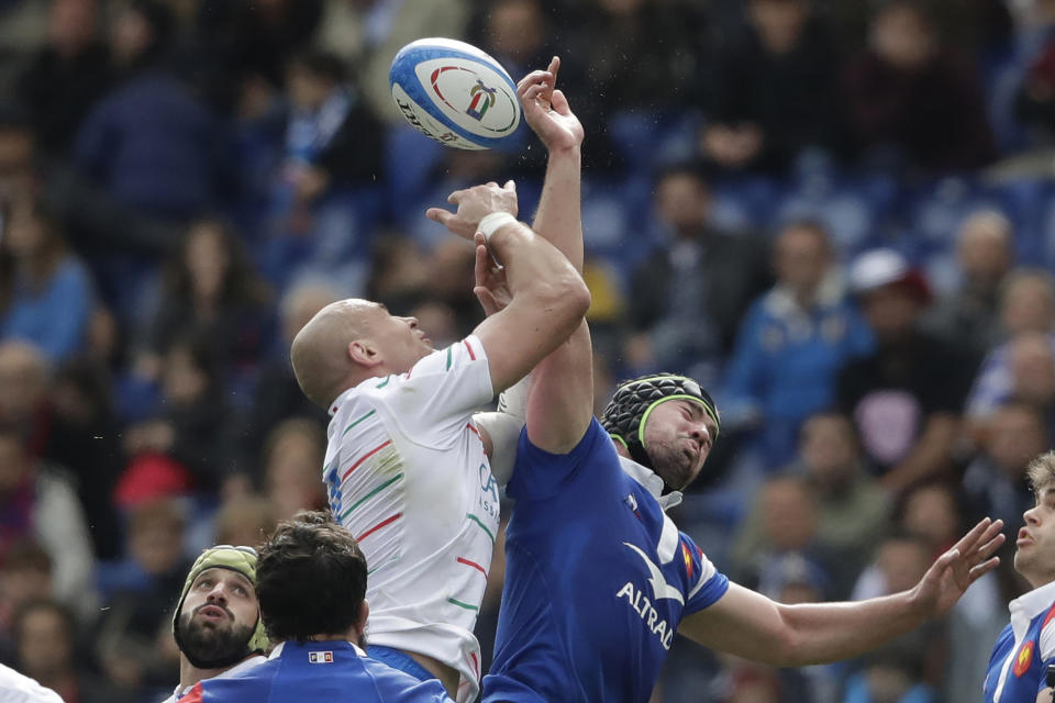 FILE - In this March 16, 2019, file photo, France's Gregory Alldritt, right, goes for the ball with Italy's Sergio Parisse during a Six Nations rugby union international match between Italy and France, at the Rome Olympic stadium. Five years since washing dishes in the countryside, Alldritt is pushing for a World Cup starting spot as France’s No. 8. (AP Photo/Alessandra Tarantino, File)