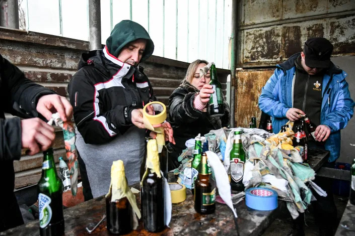 Local residents prepare Molotov cocktails.