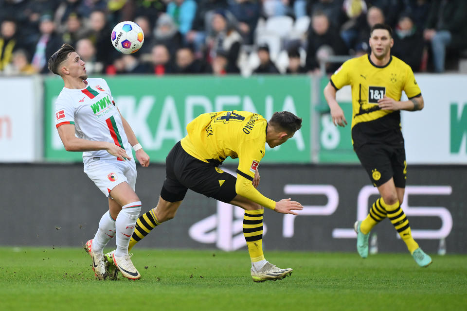 AUGSBURG, GERMANY - DECEMBER 16: Ermedin Demirovic of FC Augsburg controls the ball against Nico Schlotterbeck of Borussia Dortmund during the Bundesliga match between FC Augsburg and Borussia Dortmund at WWK-Arena on December 16, 2023 in Augsburg, Germany. (Photo by Sebastian Widmann/Getty Images)