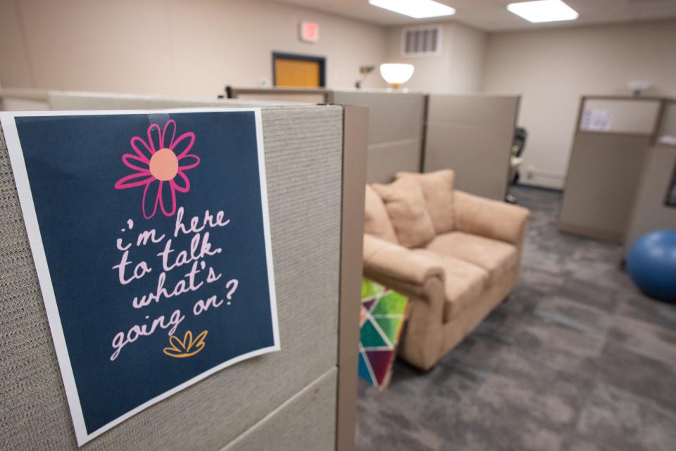 Helpful sayings are taped to cubicles within employee offices at the Kansas Suicide Prevention Headquarters. The group is working to expand ahead of the rollout of the 988 suicide prevention hotline in July, though a bill to fund and support those efforts is tied up in the Legislature.