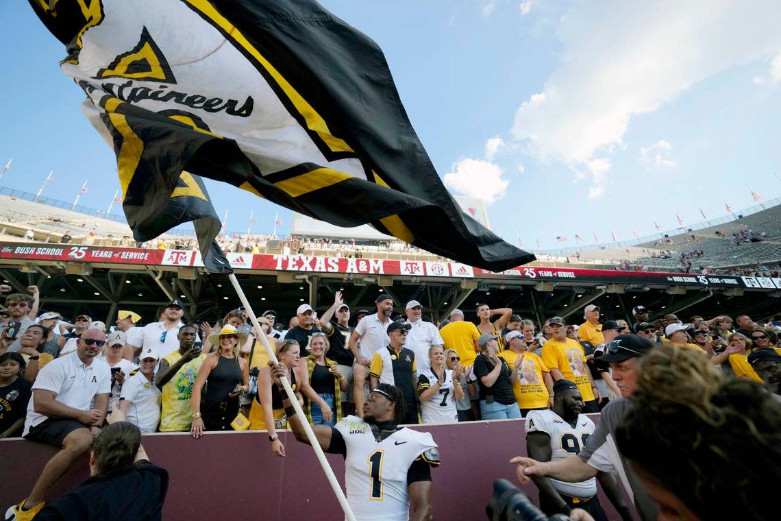 Appalachian State defensive back Kaleb Dawson (1) waves his school’s flag inside of Kyle Field after upsetting Texas A&M 17-14 in an NCAA college football game Saturday, Sept. 10, 2022, in College Station, Texas.