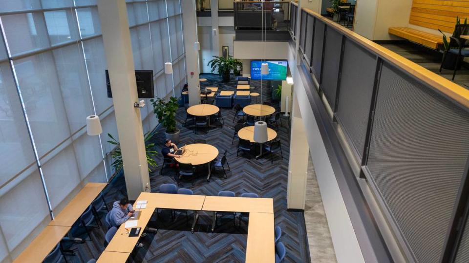 Students sit at tables inside the Academic Building at the College of Western Idaho’s main Nampa campus.